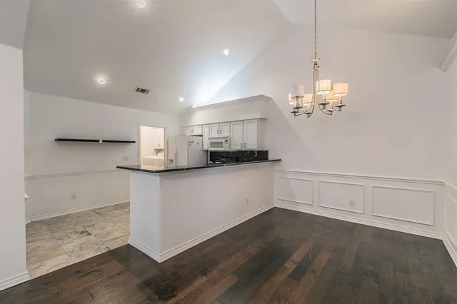 a view of a kitchen with center island and stainless steel appliances