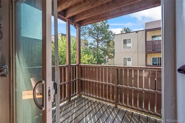 a view of balcony with wooden floor