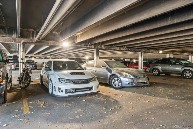 a view of parking garage with cars parked