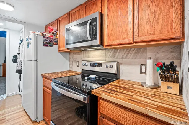 a kitchen with stainless steel appliances granite countertop a stove and a microwave