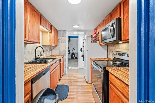 a kitchen with stainless steel appliances granite countertop a stove and a sink