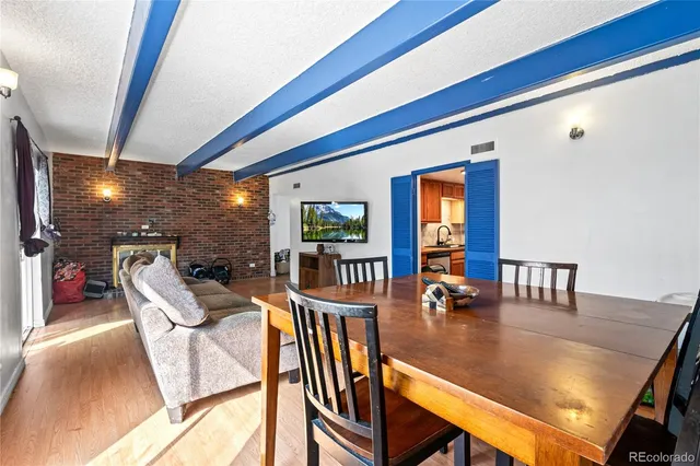 a dining room with furniture wooden floor and a floor to ceiling window