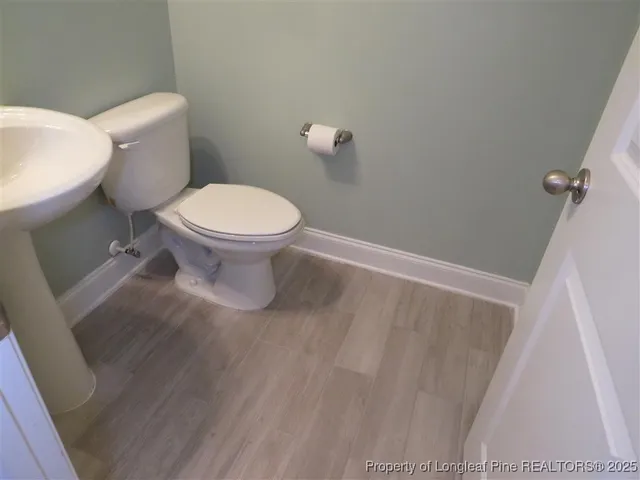 a white toilet sitting next to a white sink
