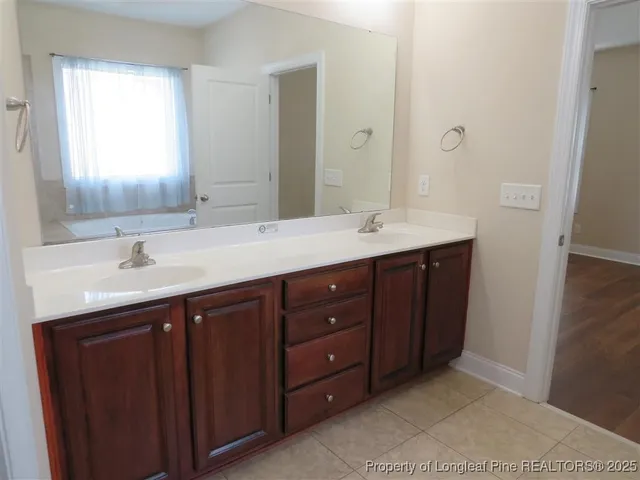 a bathroom with a double vanity sink and mirror