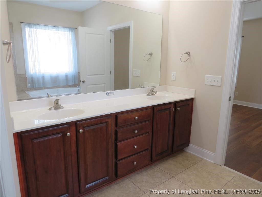 19 Turner Matthew Court Spring Lake, NC 28390 - Photo 16 of 20 a bathroom with a double vanity sink and mirror