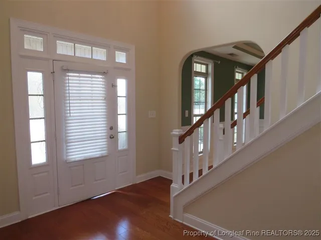 a view of an entryway wooden floor and windows