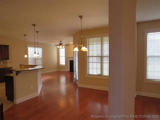a view of a kitchen with wooden floor and a window