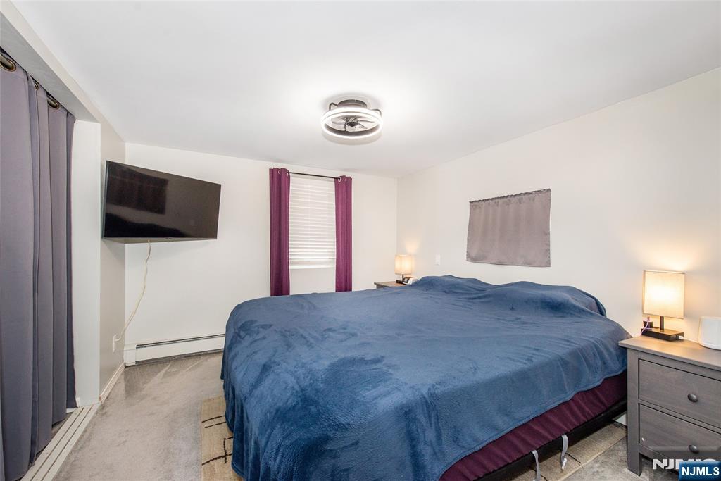 304 Squaw Trail Hopatcong, NJ 07821 - Photo 14 of 20 a bedroom with a bed and a flat screen tv