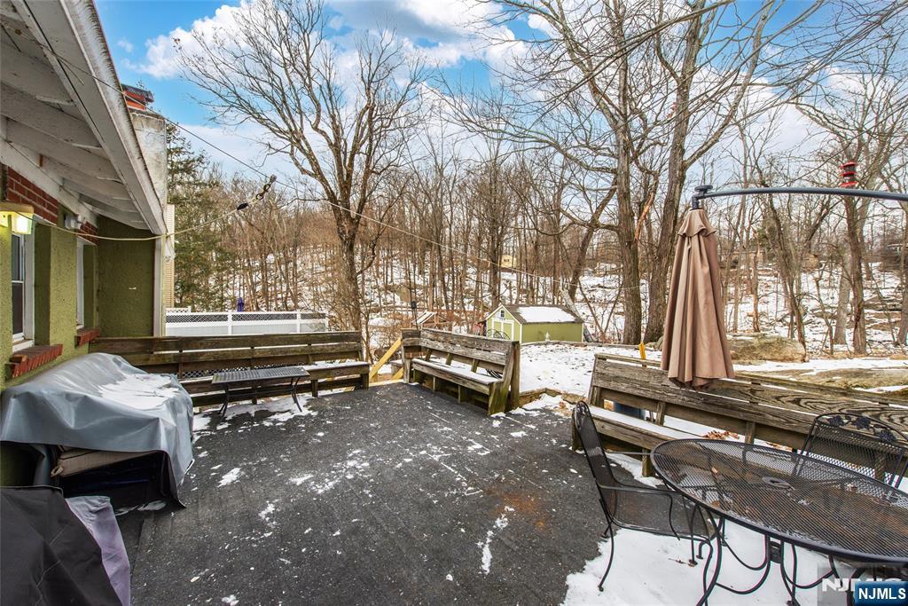 304 Squaw Trail Hopatcong, NJ 07821 - Photo 17 of 20 a backyard of a house with barbeque oven table and chairs
