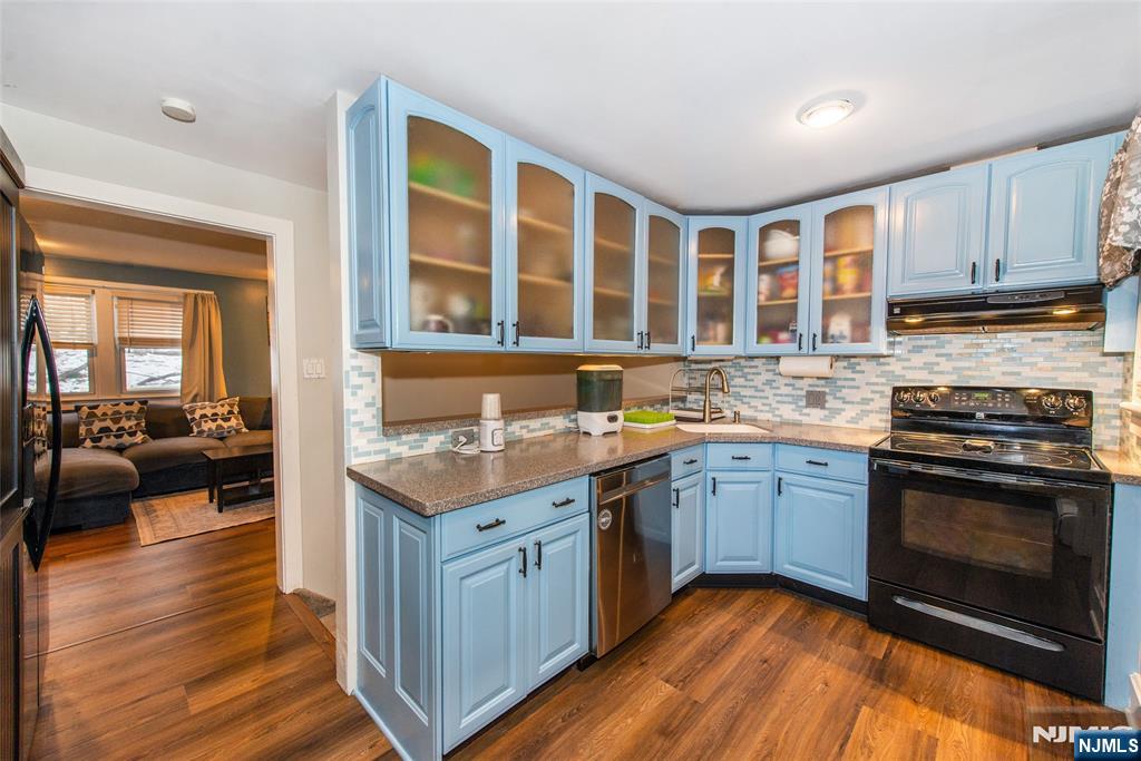 304 Squaw Trail Hopatcong, NJ 07821 - Photo 5 of 20 a kitchen with stainless steel appliances granite countertop a stove and a sink