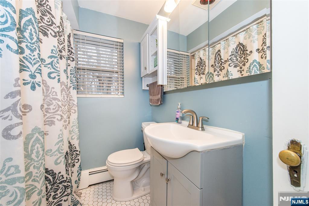 304 Squaw Trail Hopatcong, NJ 07821 - Photo 7 of 20 a bathroom with a sink toilet and mirror