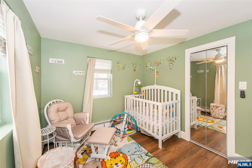 304 Squaw Trail Hopatcong, NJ 07821 - Photo 9 of 20 a bedroom with a bed and wooden floor