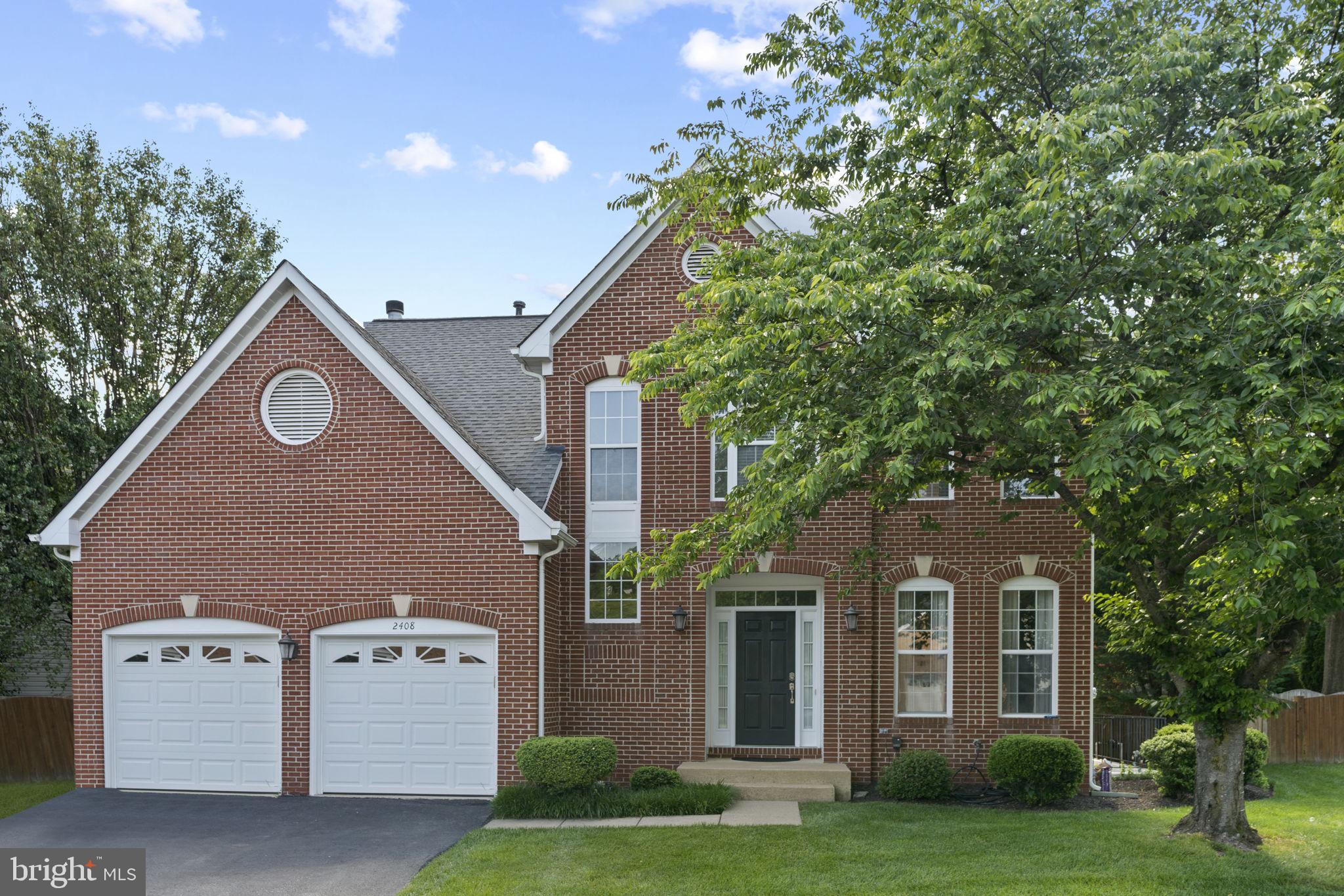 2408 Ripplemeade Court Herndon, VA 20171 - Photo 2 of 36 a front view of a house with a garden and yard