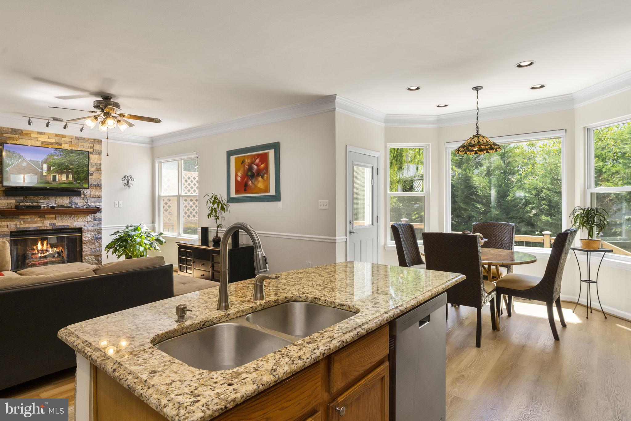 2408 Ripplemeade Court Herndon, VA 20171 - Photo 3 of 36 a kitchen with a table chairs and a flat screen tv