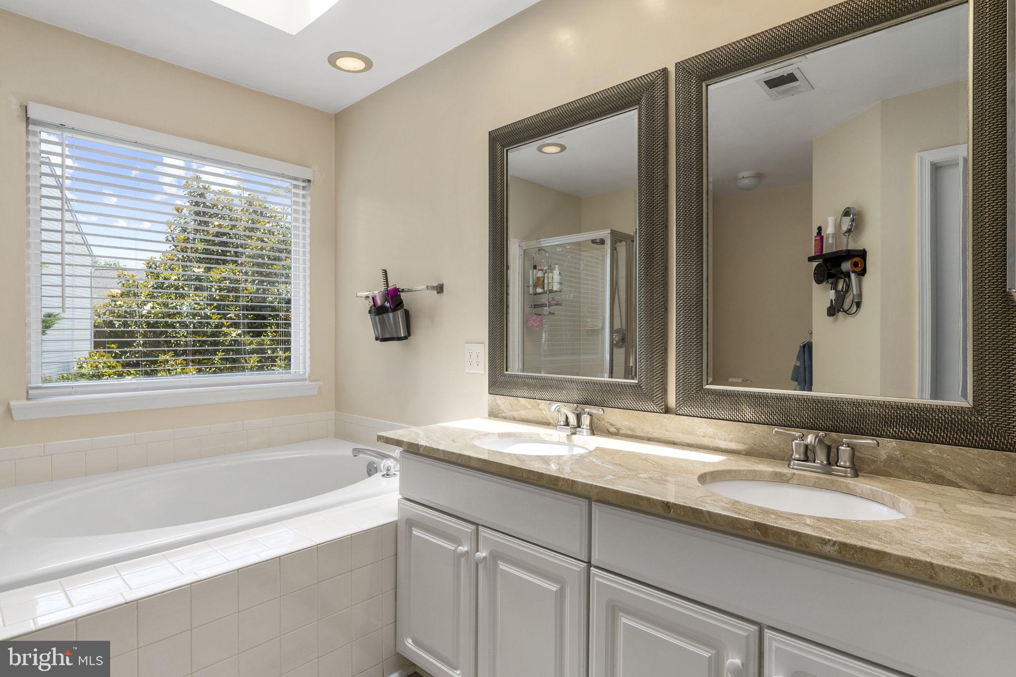 2408 Ripplemeade Court Herndon, VA 20171 - Photo 21 of 36 a bathroom with a granite countertop sink tub and mirror