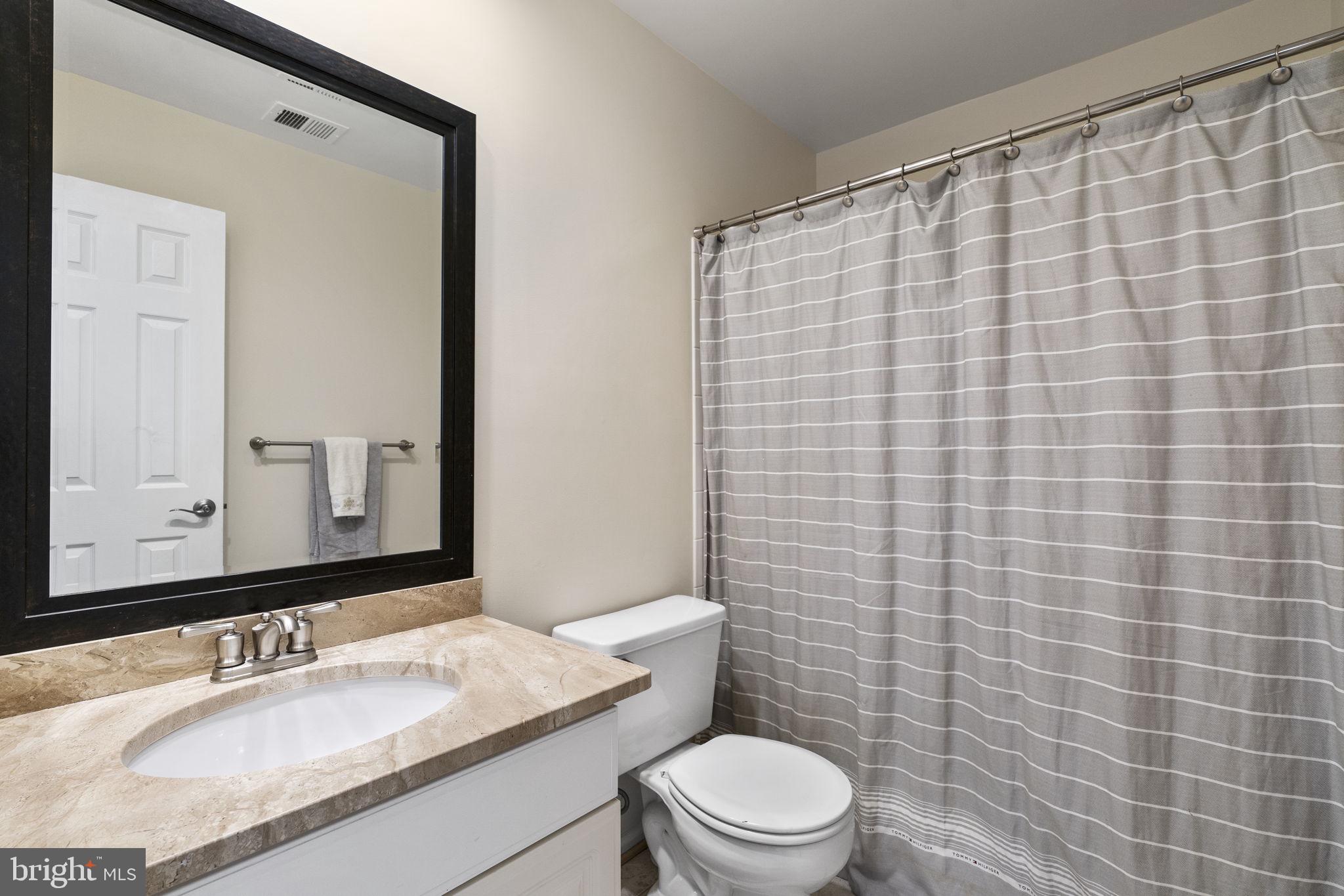 2408 Ripplemeade Court Herndon, VA 20171 - Photo 23 of 36 a bathroom with a granite countertop toilet sink and mirror