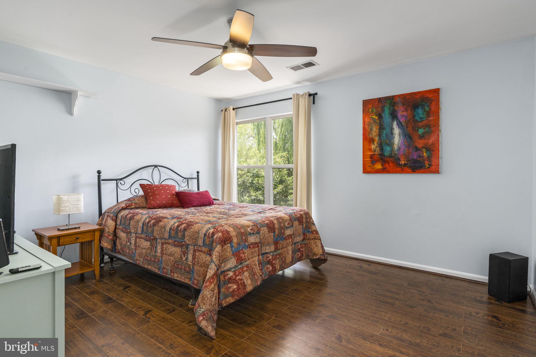 2408 Ripplemeade Court Herndon, VA 20171 - Photo 25 of 36 a bedroom with a bed a window and a chandelier