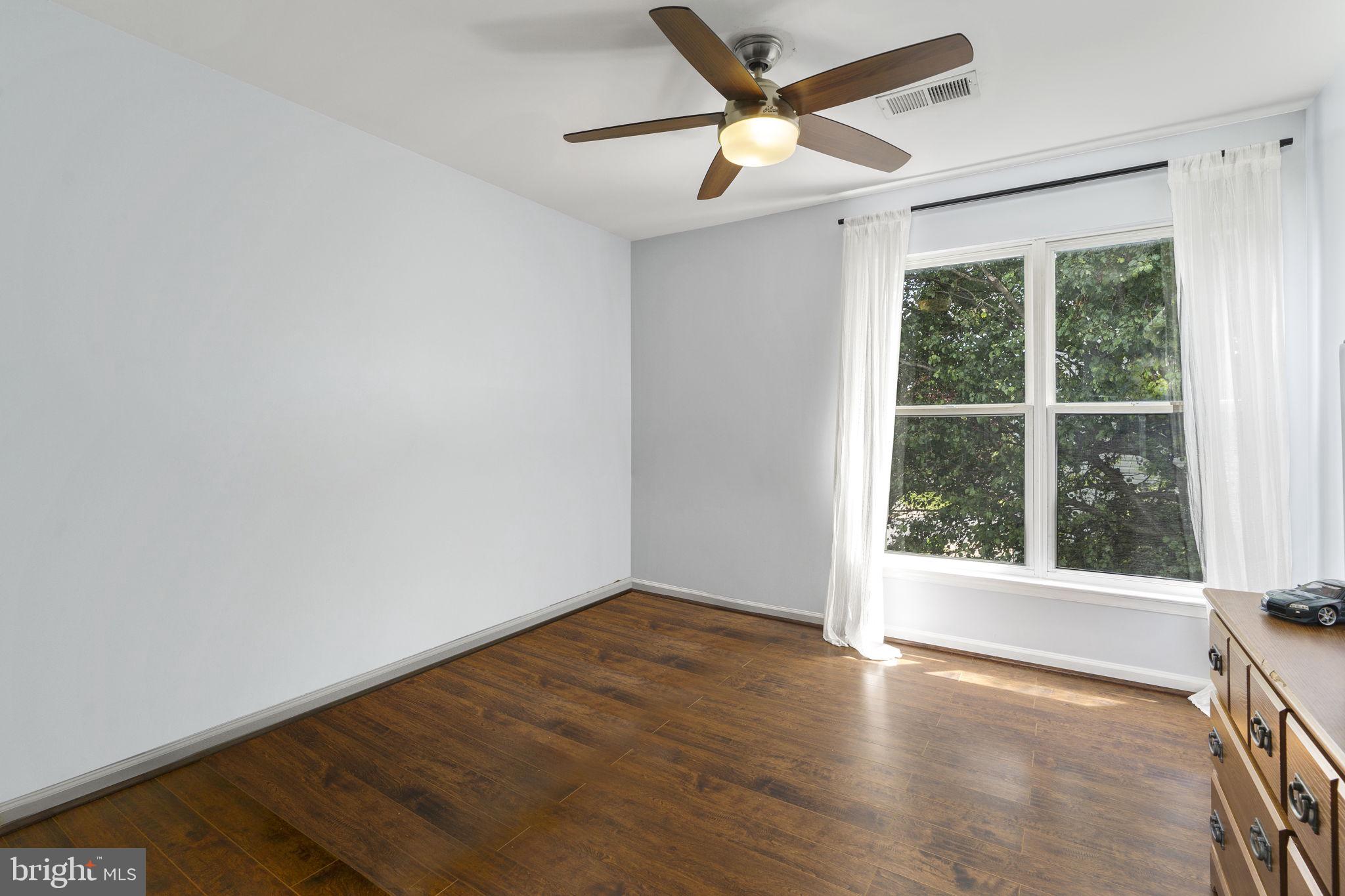 2408 Ripplemeade Court Herndon, VA 20171 - Photo 26 of 36 an empty room with wooden floor and windows