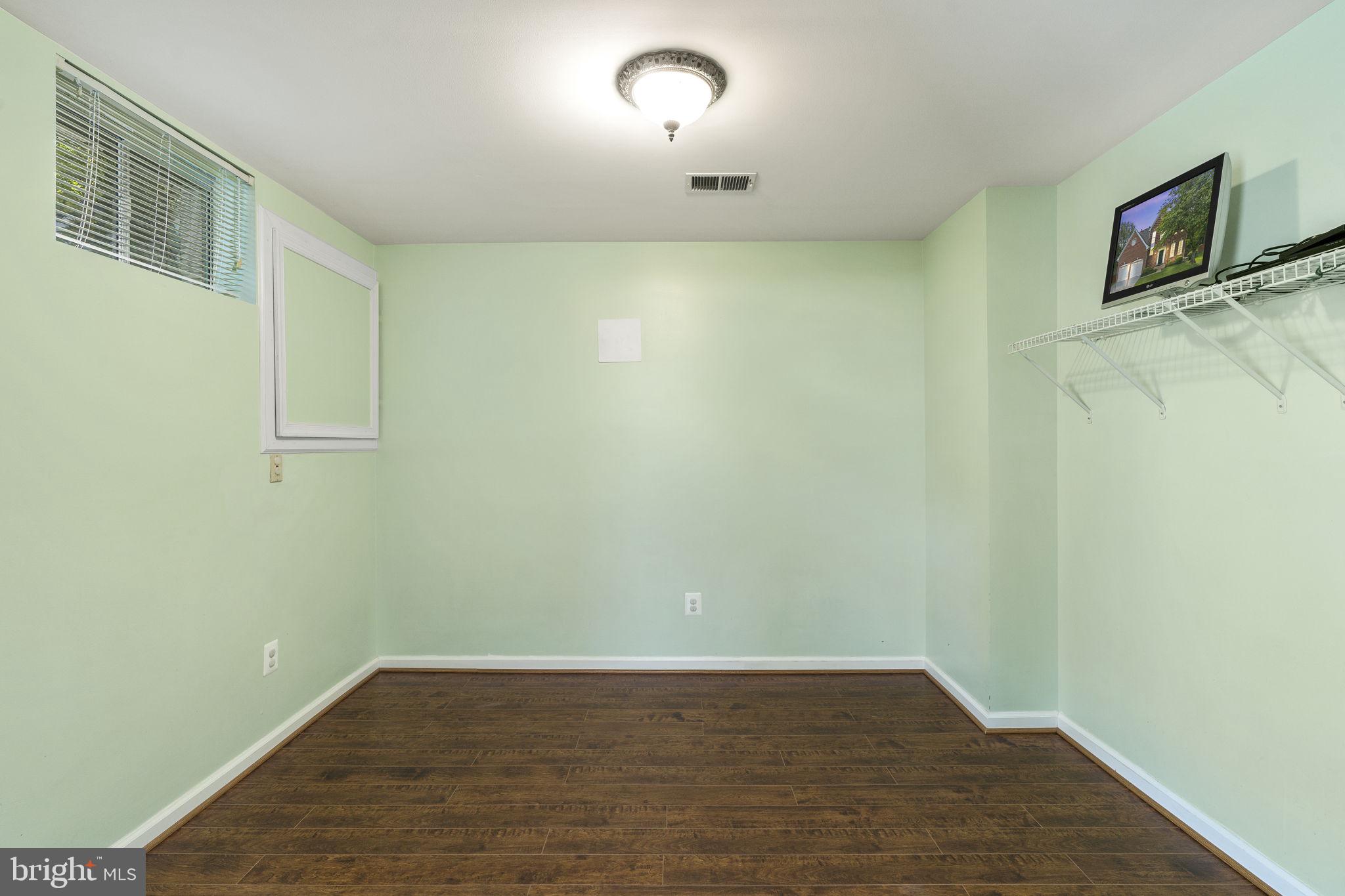 2408 Ripplemeade Court Herndon, VA 20171 - Photo 30 of 36 a view of an empty room with wooden floor and a window