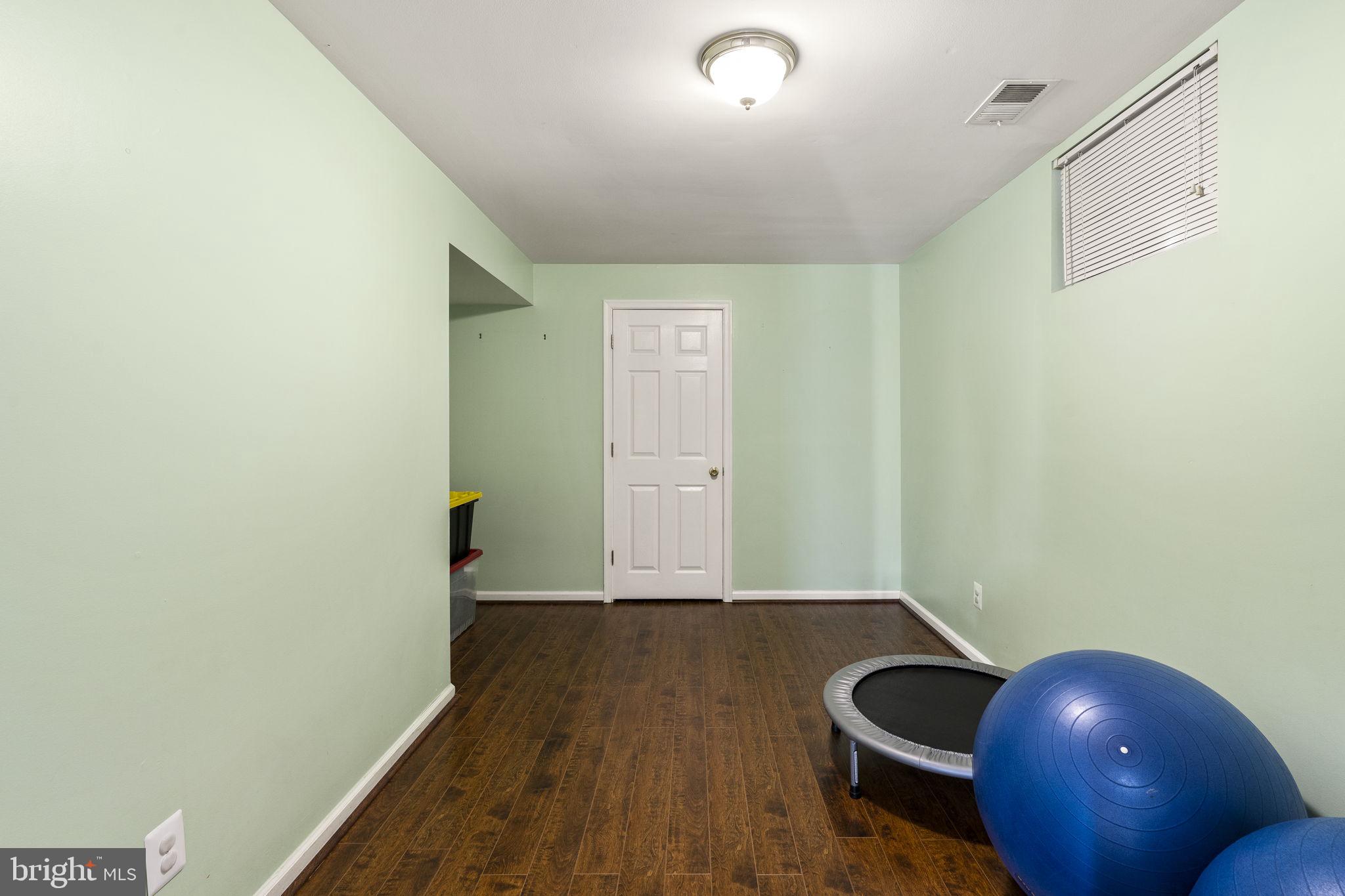 2408 Ripplemeade Court Herndon, VA 20171 - Photo 31 of 36 a view of an empty room with wooden floor