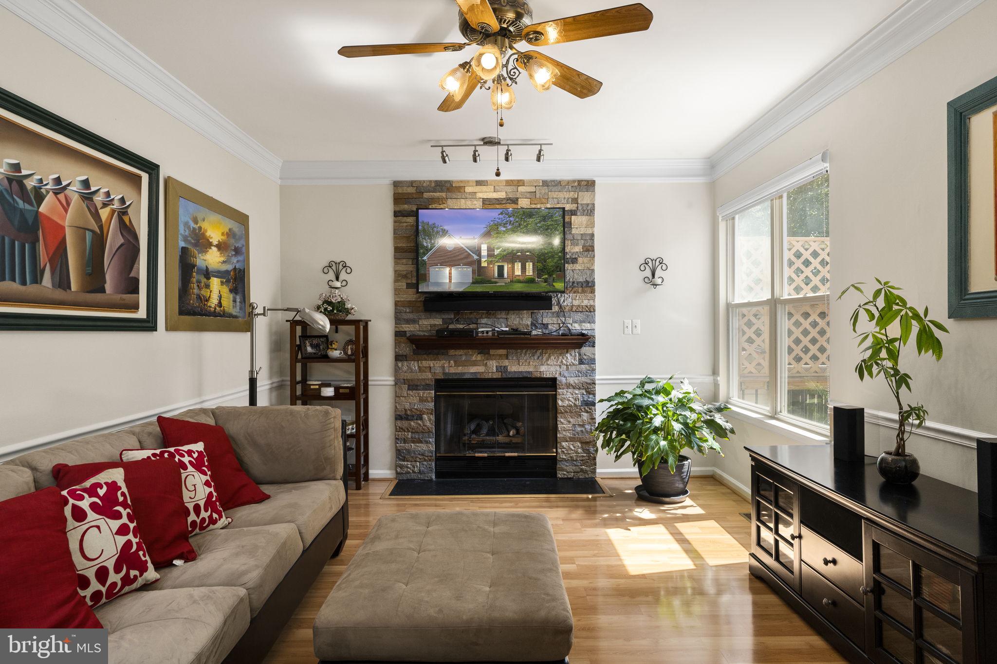 2408 Ripplemeade Court Herndon, VA 20171 - Photo 8 of 36 a living room with furniture a fireplace and a flat screen tv