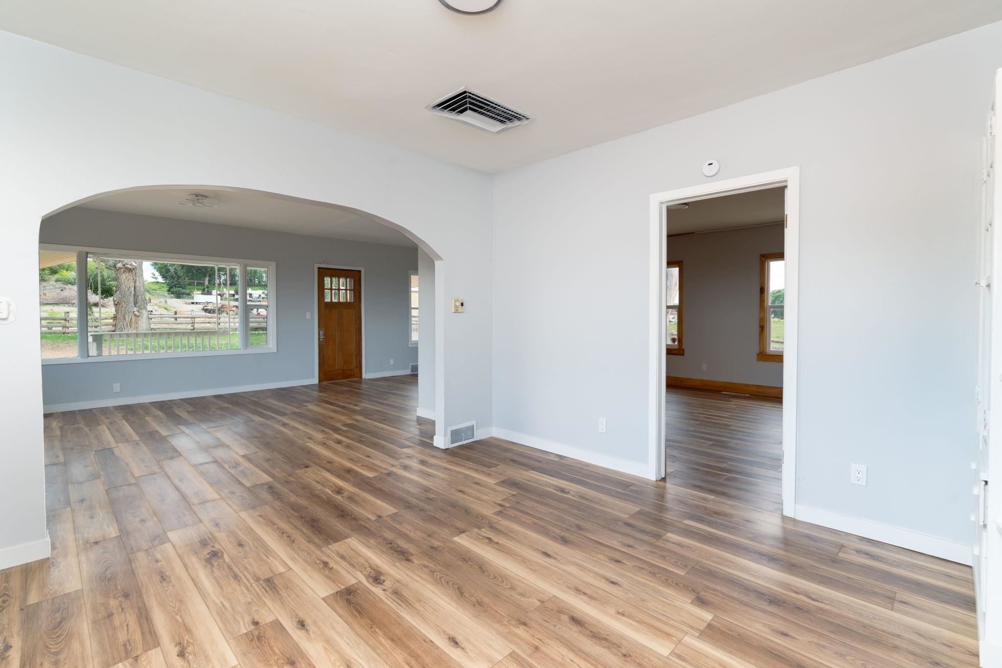 6038 Townsend Road Delta, CO 81416 - Photo 11 of 42 an empty room with wooden floor and a window