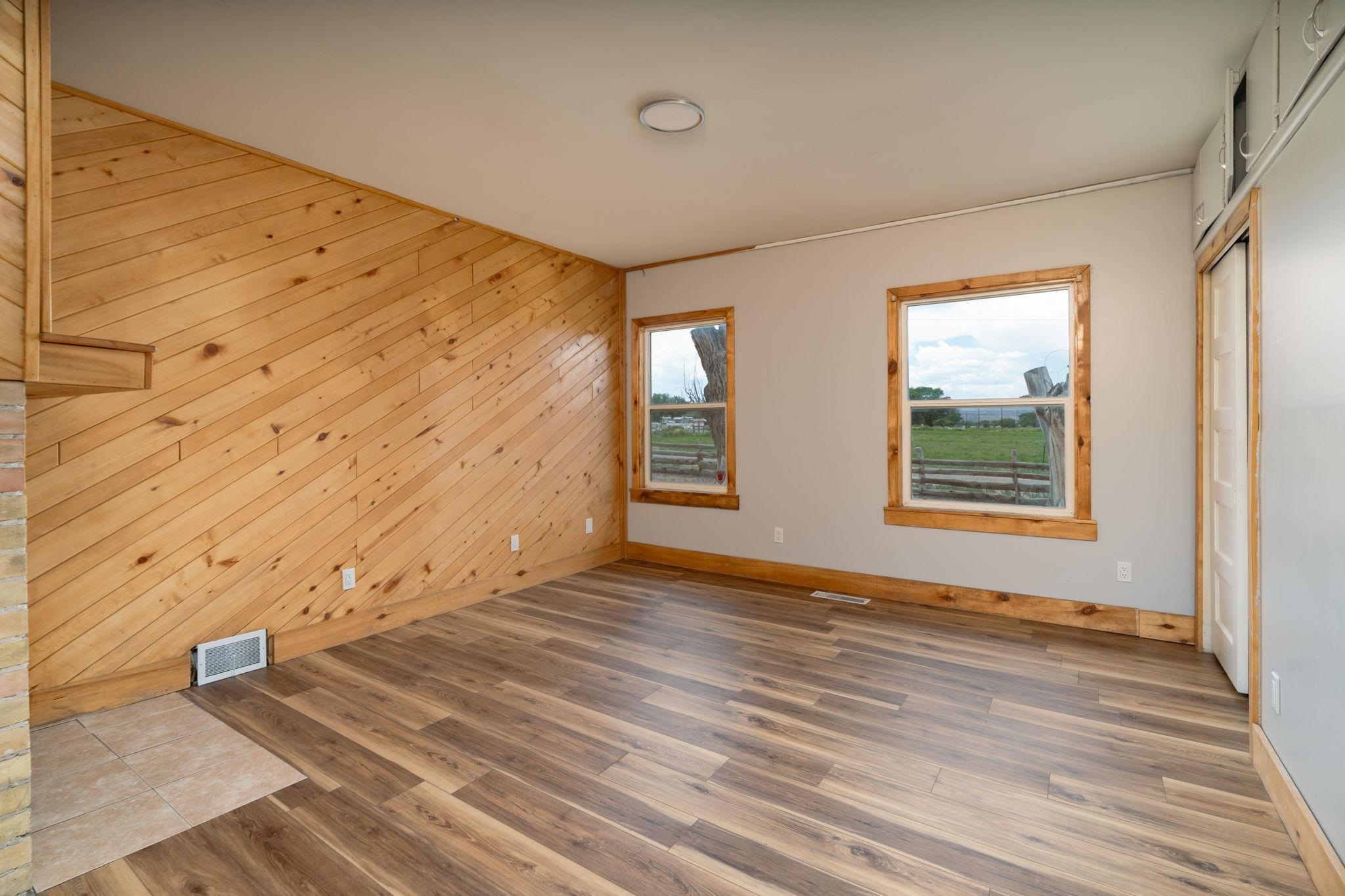 6038 Townsend Road Delta, CO 81416 - Photo 13 of 42 a view of an empty room with wooden floor and a window
