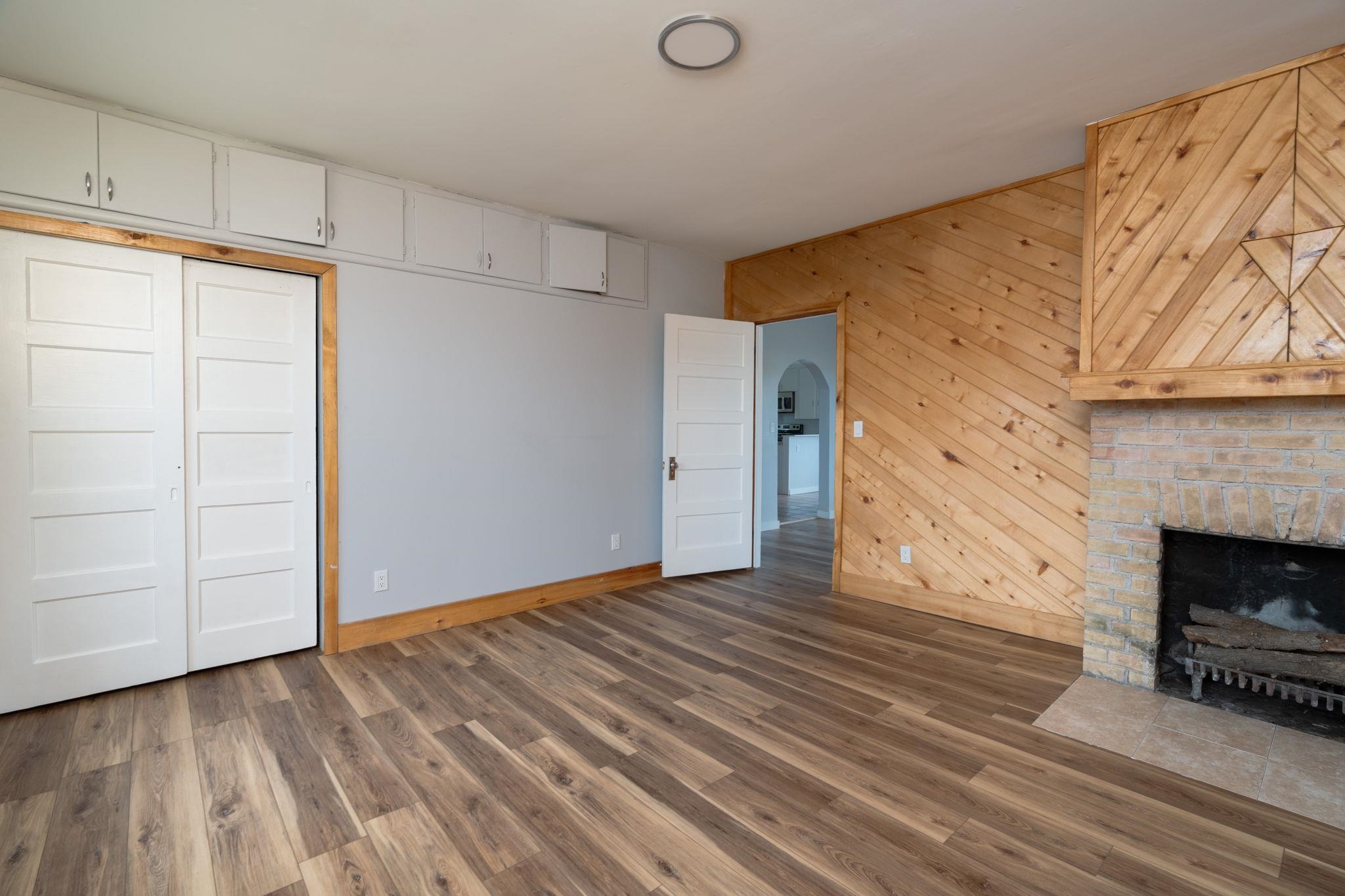 6038 Townsend Road Delta, CO 81416 - Photo 15 of 42 a view of empty room with wooden floor and fireplace