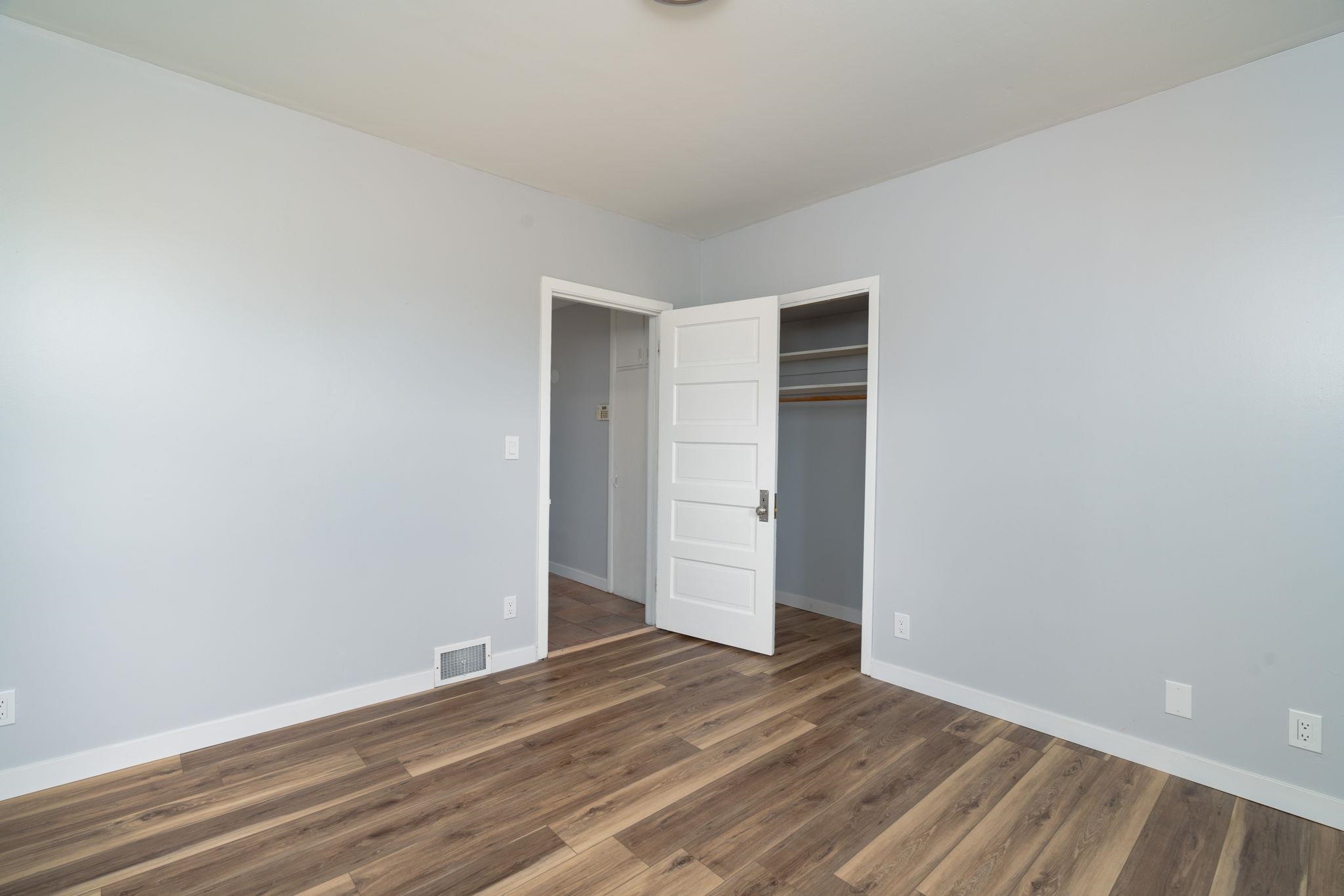 6038 Townsend Road Delta, CO 81416 - Photo 18 of 42 a view of an empty room with wooden floor and closet