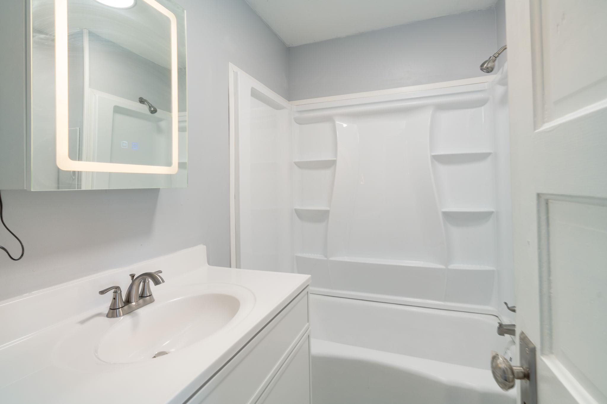 6038 Townsend Road Delta, CO 81416 - Photo 19 of 42 a white bath tub sitting next to a white sink
