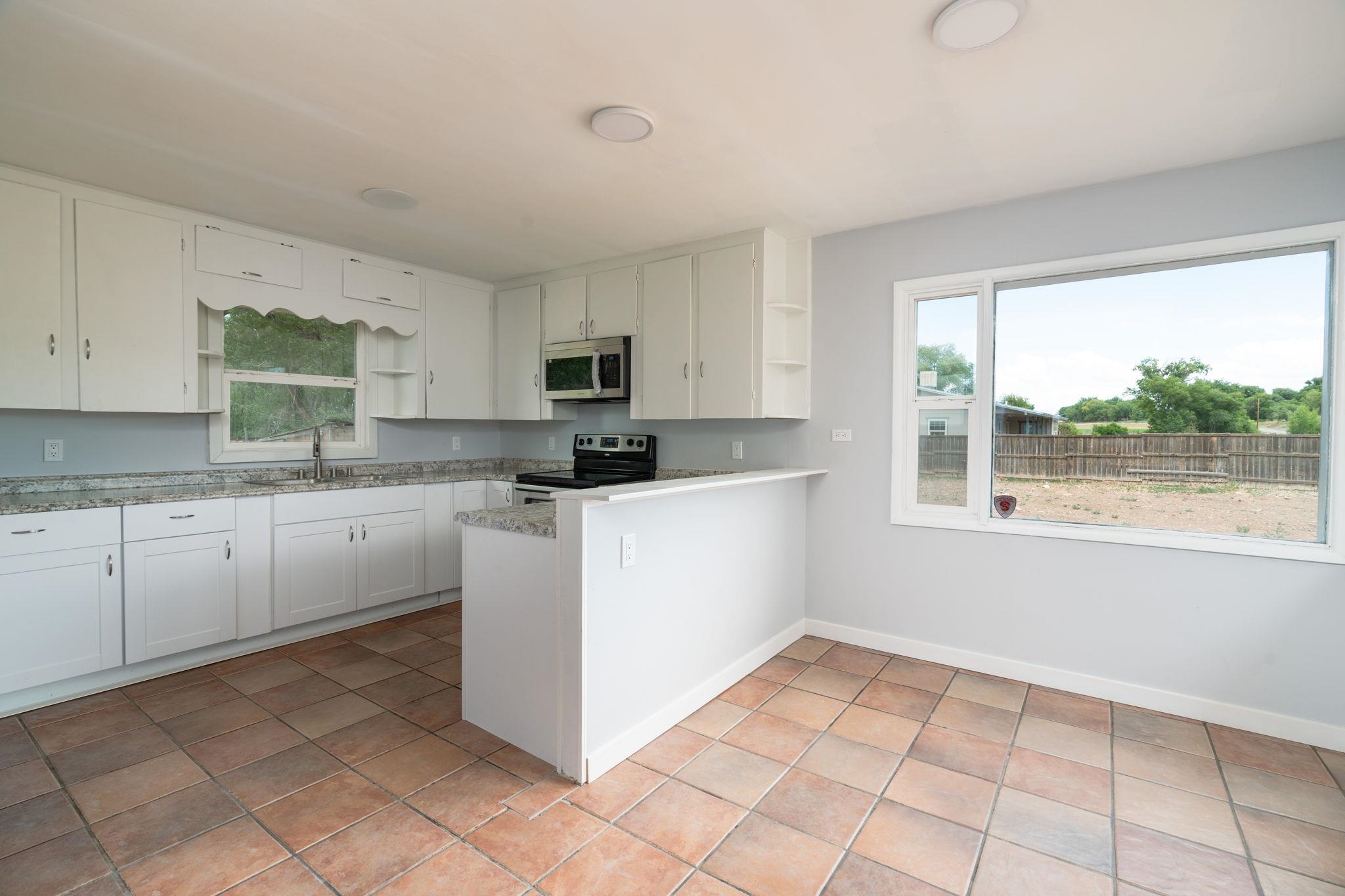 6038 Townsend Road Delta, CO 81416 - Photo 20 of 42 a kitchen with a stove a sink dishwasher and a refrigerator