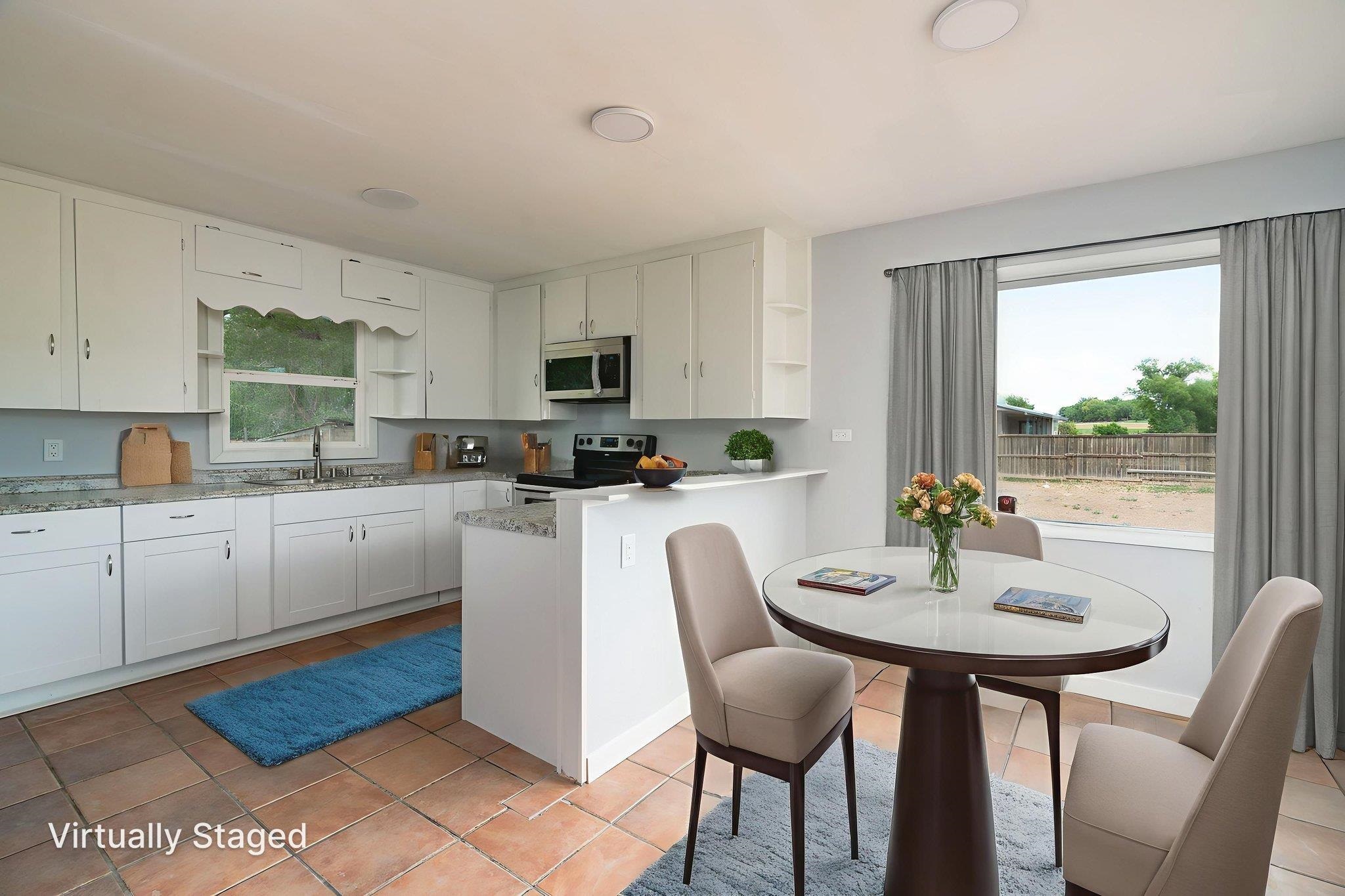 6038 Townsend Road Delta, CO 81416 - Photo 21 of 42 a kitchen with a table chairs microwave and cabinets