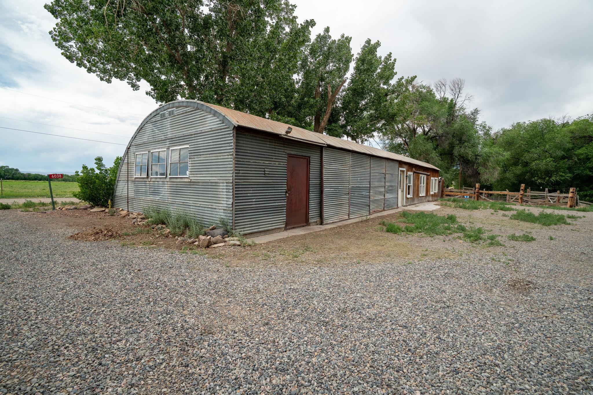 6038 Townsend Road Delta, CO 81416 - Photo 34 of 42 a backyard of a house with large trees and wooden fence