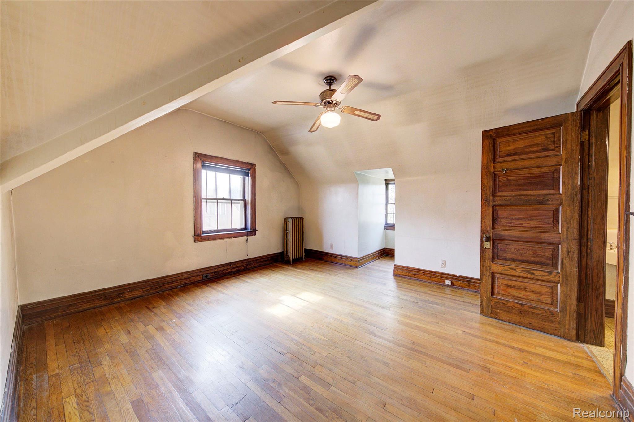 121 Longfellow Street Detroit, MI 48202 - Photo 57 of 87 Additional living space with light wood-style floors, ceiling fan, vaulted ceiling, and radiator heating unit