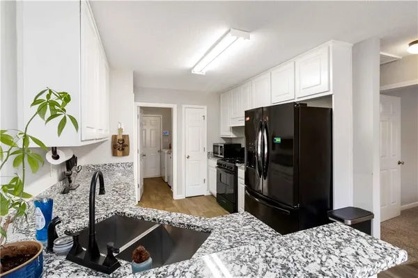 a kitchen with a refrigerator and a sink