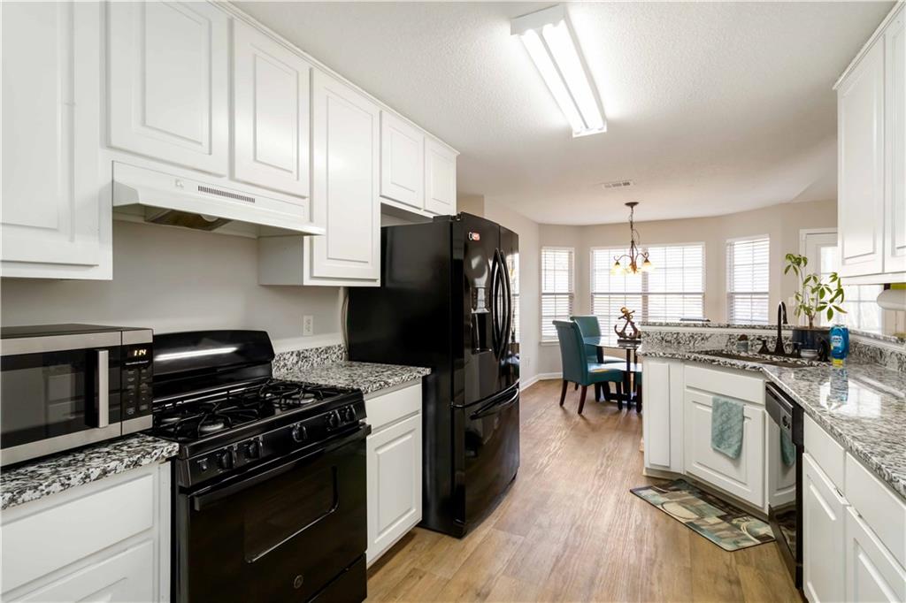 101 River View Court Hampton, GA 30228 - Photo 12 of 29 a kitchen with a stove a sink and a refrigerator