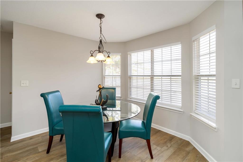 101 River View Court Hampton, GA 30228 - Photo 13 of 29 a dining room with furniture a chandelier and wooden floor