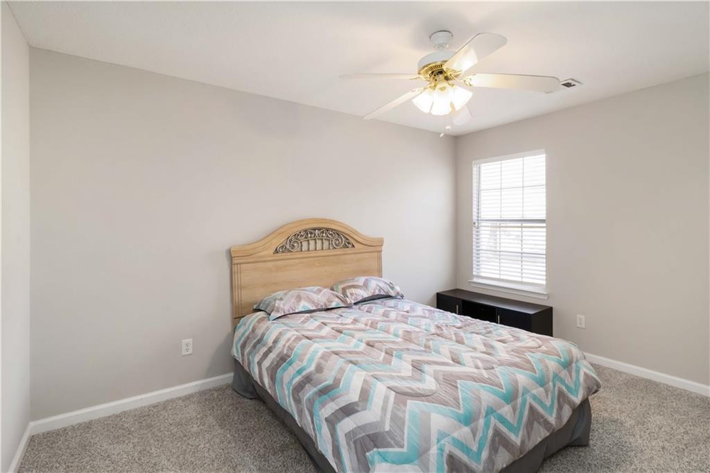 101 River View Court Hampton, GA 30228 - Photo 14 of 29 a bedroom with a bed and a chandelier