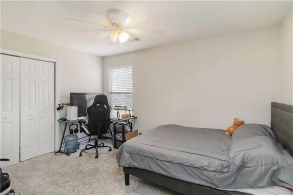 a bedroom with a bed and a chair