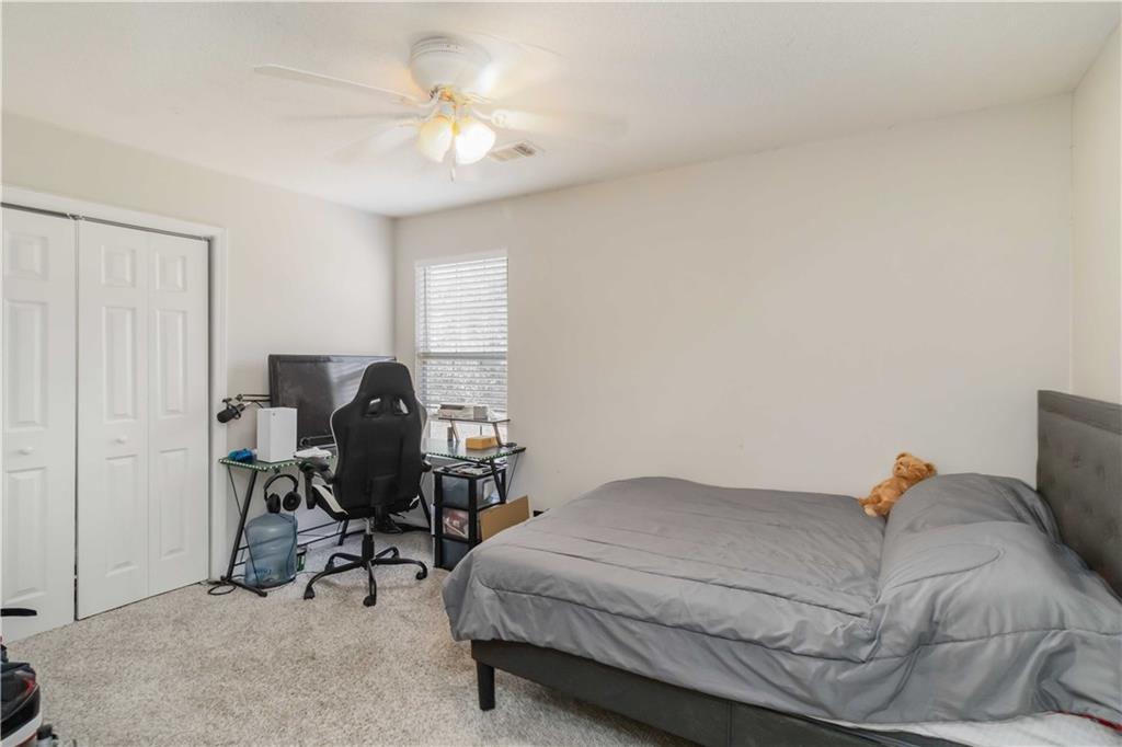 101 River View Court Hampton, GA 30228 - Photo 16 of 29 a bedroom with a bed and a chair