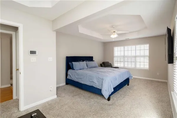 a spacious bedroom with a bed and a window