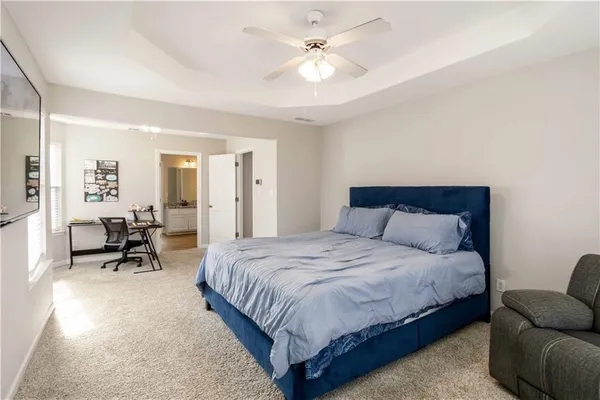 a bedroom with bed and a chandelier