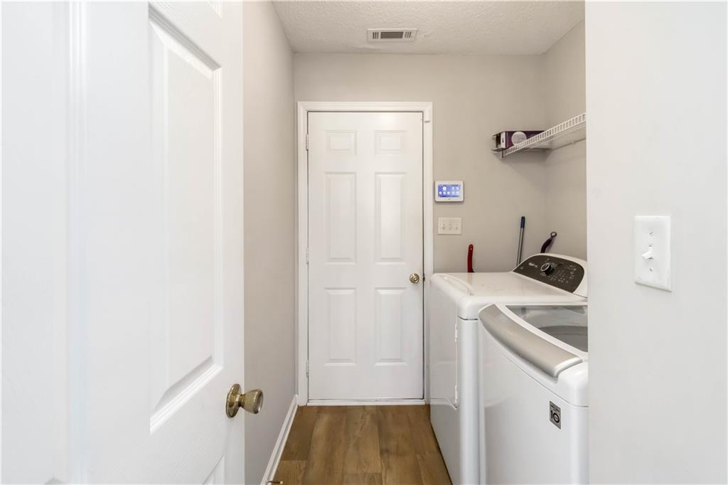 101 River View Court Hampton, GA 30228 - Photo 19 of 29 a storage room with a washer and dryer