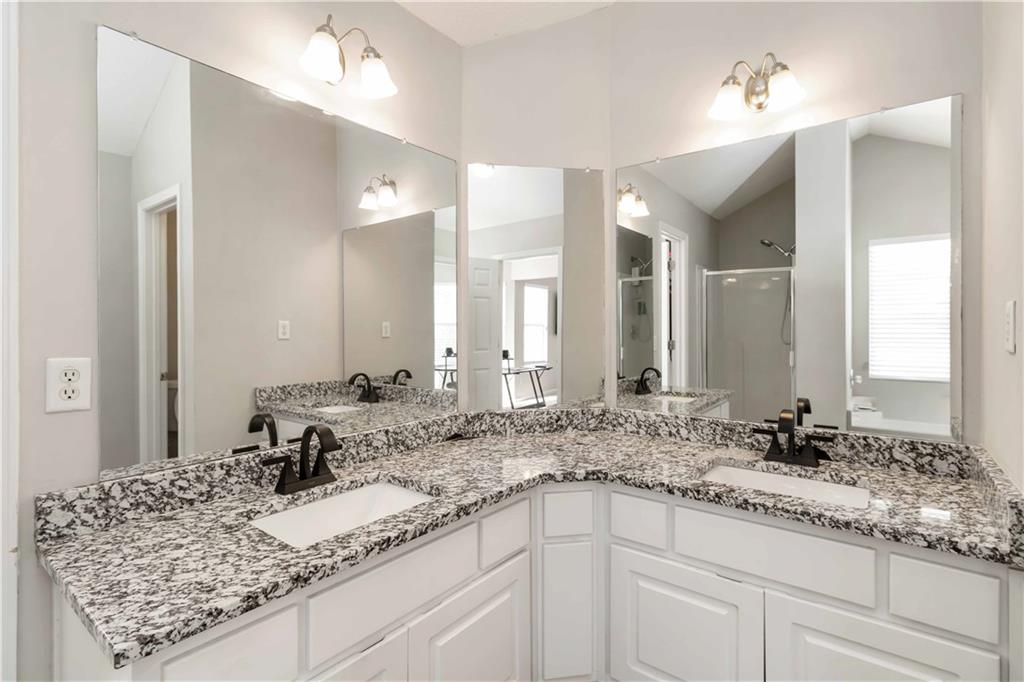 101 River View Court Hampton, GA 30228 - Photo 21 of 29 a bathroom with a granite countertop sink and a mirror