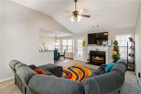a living room with furniture flat screen tv and a fireplace
