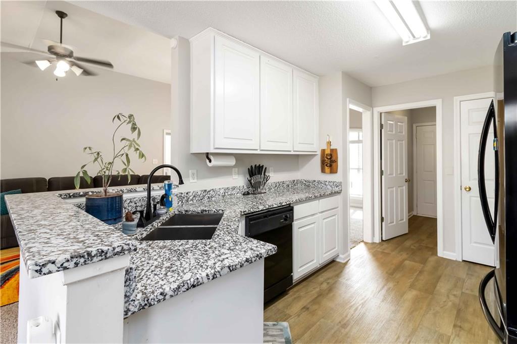 101 River View Court Hampton, GA 30228 - Photo 10 of 29 a kitchen with stainless steel appliances granite countertop a sink stove and refrigerator