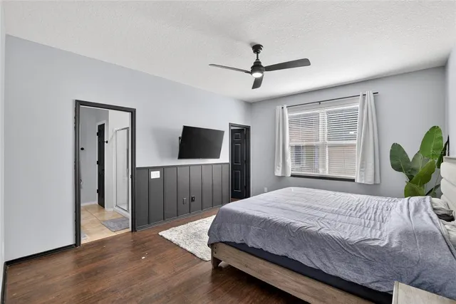 a bedroom with a bed and wooden floor