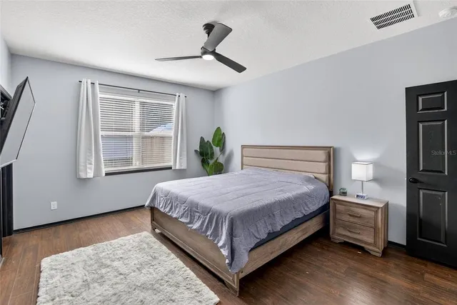 a bedroom with a bed and a potted plant