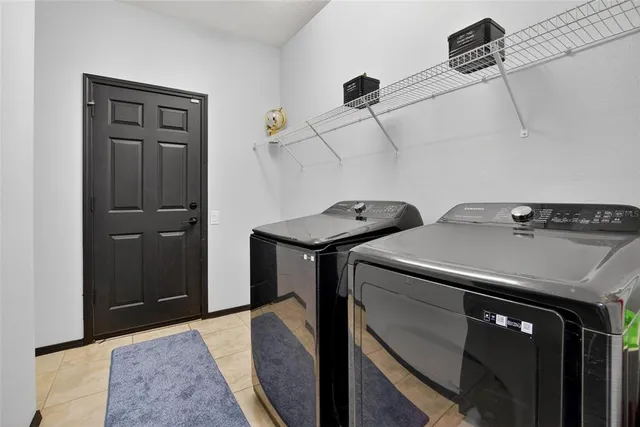 an empty room with wooden floor cabinet and windows
