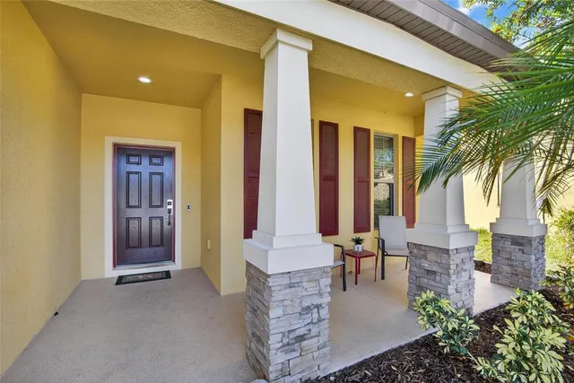 a front view of a house with outdoor seating